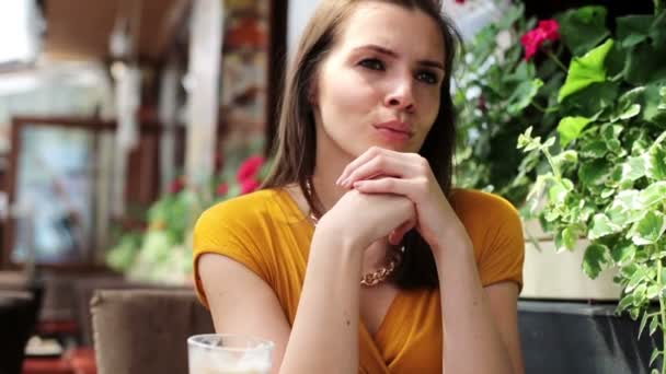 Portrait of beautiful sad, serious woman in restaurant — Stock Video