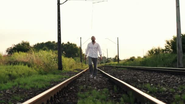 Man walking on railroad tracks — Stock Video