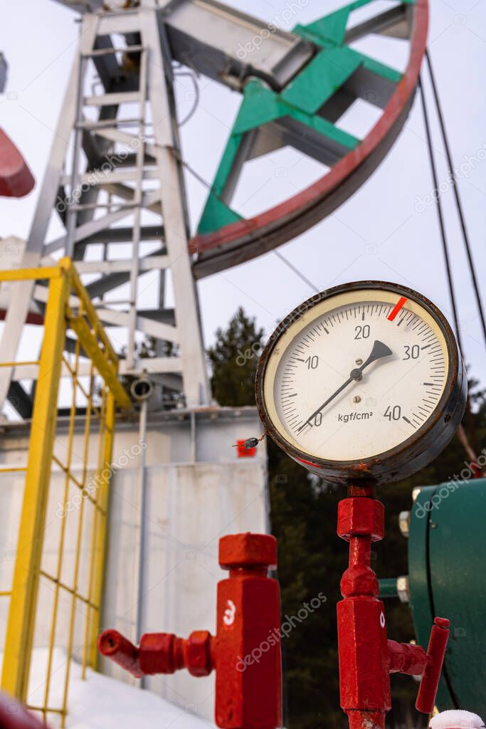Russia Pipeline Manometer Oil pressure gauge shows 0 (Max 25 Bar - red line). Oil pumpjack. A pumpjack is the overground drive for a reciprocating piston pump in an oil well.