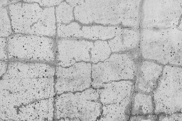 Concrete with crack broken in floor wall texture. Chapped surface asphalt old cement stone. Natural destruction from time and weather conditions. Non-color, monochrome black and white photo.