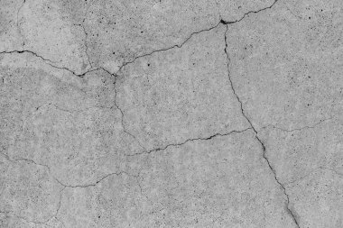 Çatlak arka planı olan bir beton. Eski kırık beton zemin duvarı. Çatlak taş asfalt yüzey dokusu. Kopyalama alanı için gri renk..