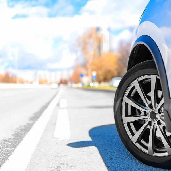 Wheel of Car on asphalt road in summer, standing on the Road Beautiful day at City with Copyspace