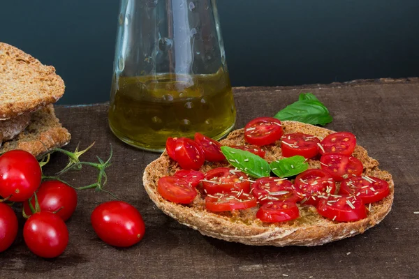 Friselle with tomatoes photographed on a wooden base — Stock Photo, Image