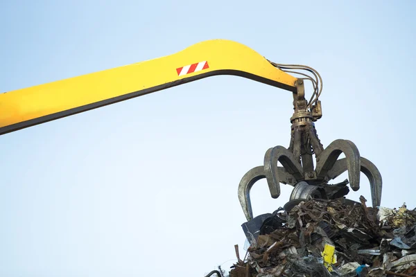 Großer Raupenbagger bei der Arbeit an einem Stahlpfahl an einem Metallrecycling — Stockfoto