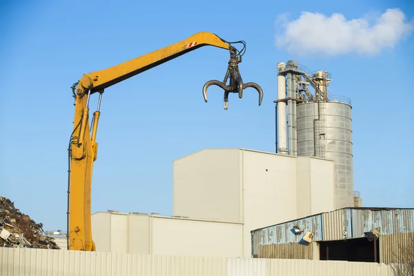 Gru raccogliendo rottami metallici nel sito di riciclaggio all'aperto — Foto Stock