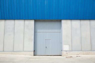 Shutter door, outside of factory. clipart