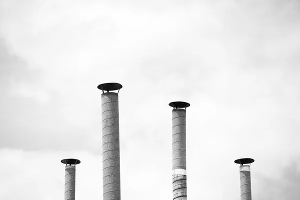 Четыре вентиляционных трубы над голубым небом — стоковое фото