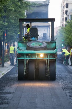 Heavy Vibration roller compactor at asphalt pavement works for r clipart