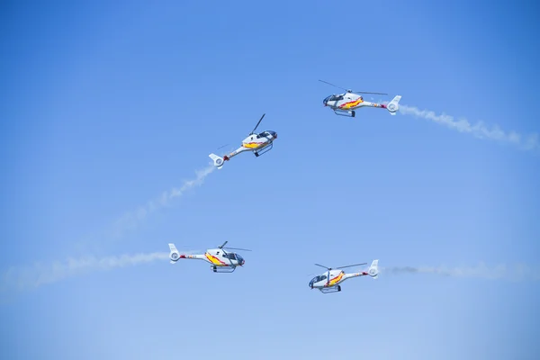 GRANADA,SPAIN - May 18: Aerobatic Spanish helicopter patrol (ASPA Patrol) perform at airshow (10 Aanniversary of Aspa Patrol in Granada) on May 18, 2014 in Granada ,Spain — Stock Photo, Image