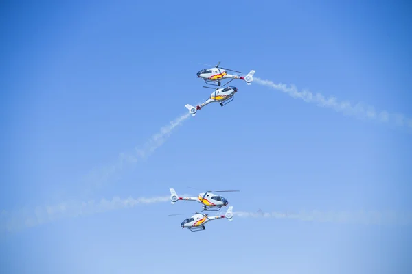 GRANADA,SPAIN - May 18: Aerobatic Spanish helicopter patrol (ASPA Patrol) perform at airshow (10 Aanniversary of Aspa Patrol in Granada) on May 18, 2014 in Granada ,Spain — Stock Photo, Image