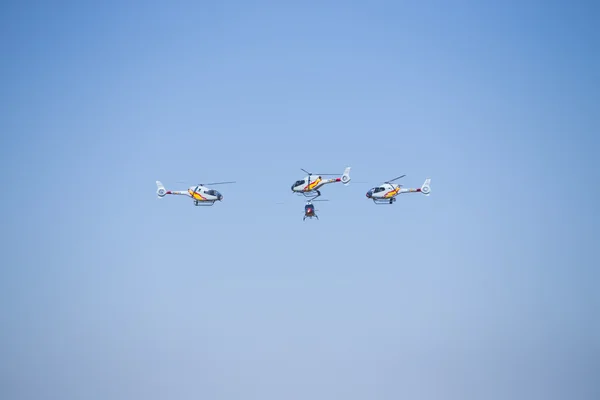 GRANADA,SPAIN - May 18: Aerobatic Spanish helicopter patrol (ASPA Patrol) perform at airshow (10 Aanniversary of Aspa Patrol in Granada) on May 18, 2014 in Granada ,Spain — Stock Photo, Image