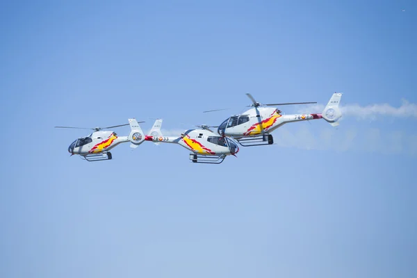 GRANADA,SPAIN - May 18: Aerobatic Spanish helicopter patrol (ASPA Patrol) perform at airshow (10 Aanniversary of Aspa Patrol in Granada) on May 18, 2014 in Granada ,Spain — Stock Photo, Image