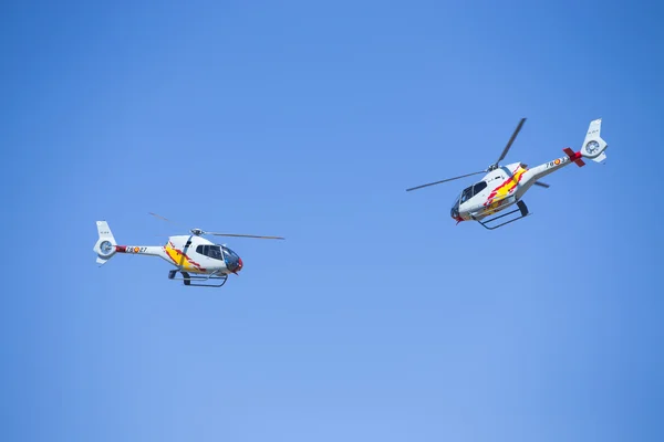 GRANADA,SPAIN - May 18: Aerobatic Spanish helicopter patrol (ASPA Patrol) perform at airshow (10 Aanniversary of Aspa Patrol in Granada) on May 18, 2014 in Granada ,Spain — Stock Photo, Image