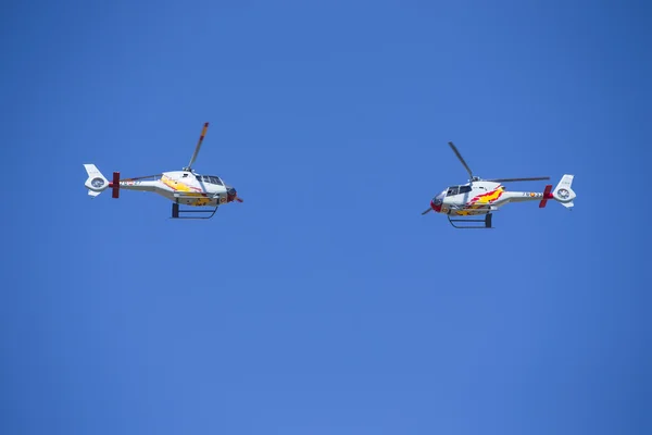 GRANADA,SPAIN - May 18: Aerobatic Spanish helicopter patrol (ASPA Patrol) perform at airshow (10 Aanniversary of Aspa Patrol in Granada) on May 18, 2014 in Granada ,Spain — Stock Photo, Image