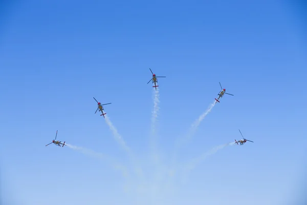 GRANADA,SPAIN - May 18: Aerobatic Spanish helicopter patrol (ASPA Patrol) perform at airshow (10 Aanniversary of Aspa Patrol in Granada) on May 18, 2014 in Granada ,Spain — Stock Photo, Image