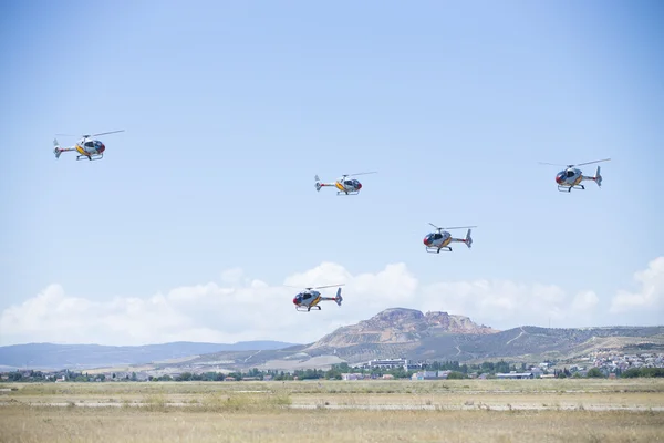 GRANADA,SPAIN - May 18: Aerobatic Spanish helicopter patrol (ASPA Patrol) perform at airshow (10 Aanniversary of Aspa Patrol in Granada) on May 18, 2014 in Granada ,Spain — Stock Photo, Image