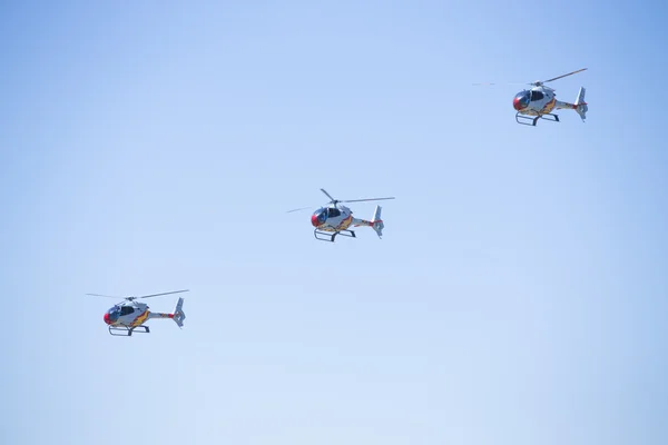 GRANADA,SPAIN - May 18: Aerobatic Spanish helicopter patrol (ASPA Patrol) perform at airshow (10 Aanniversary of Aspa Patrol in Granada) on May 18, 2014 in Granada ,Spain — Stock Photo, Image