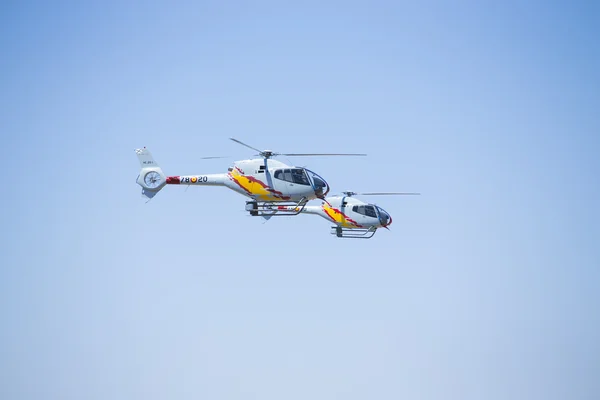 GRANADA,SPAIN - May 18: Aerobatic Spanish helicopter patrol (ASPA Patrol) perform at airshow (10 Aanniversary of Aspa Patrol in Granada) on May 18, 2014 in Granada ,Spain — Stock Photo, Image