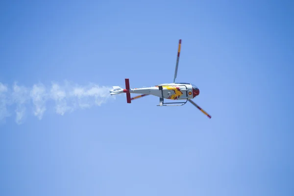 GRANADA,SPAIN - May 18: Aerobatic Spanish helicopter patrol (ASPA Patrol) perform at airshow (10 Aanniversary of Aspa Patrol in Granada) on May 18, 2014 in Granada ,Spain — Stock Photo, Image