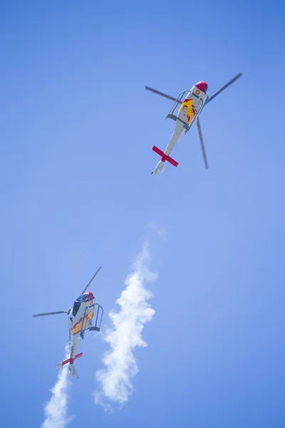 GRANADA,SPAIN - May 18: Aerobatic Spanish helicopter patrol (ASPA Patrol) perform at airshow (10 Aanniversary of Aspa Patrol in Granada) on May 18, 2014 in Granada ,Spain — Stock Photo, Image