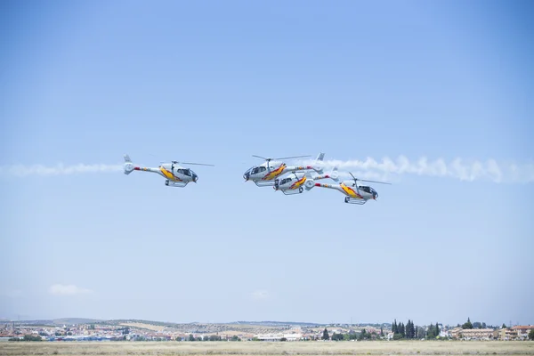 GRANADA,SPAIN - May 18: Aerobatic Spanish helicopter patrol (ASPA Patrol) perform at airshow (10 Aanniversary of Aspa Patrol in Granada) on May 18, 2014 in Granada ,Spain — Stock Photo, Image