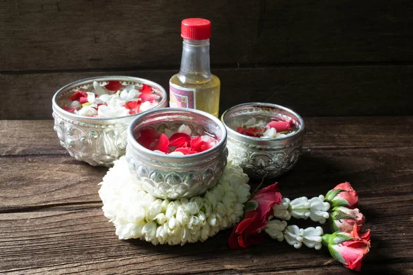 Eau dans un bol mélangé avec du parfum et des fleurs corolle pour Songkra — Photo
