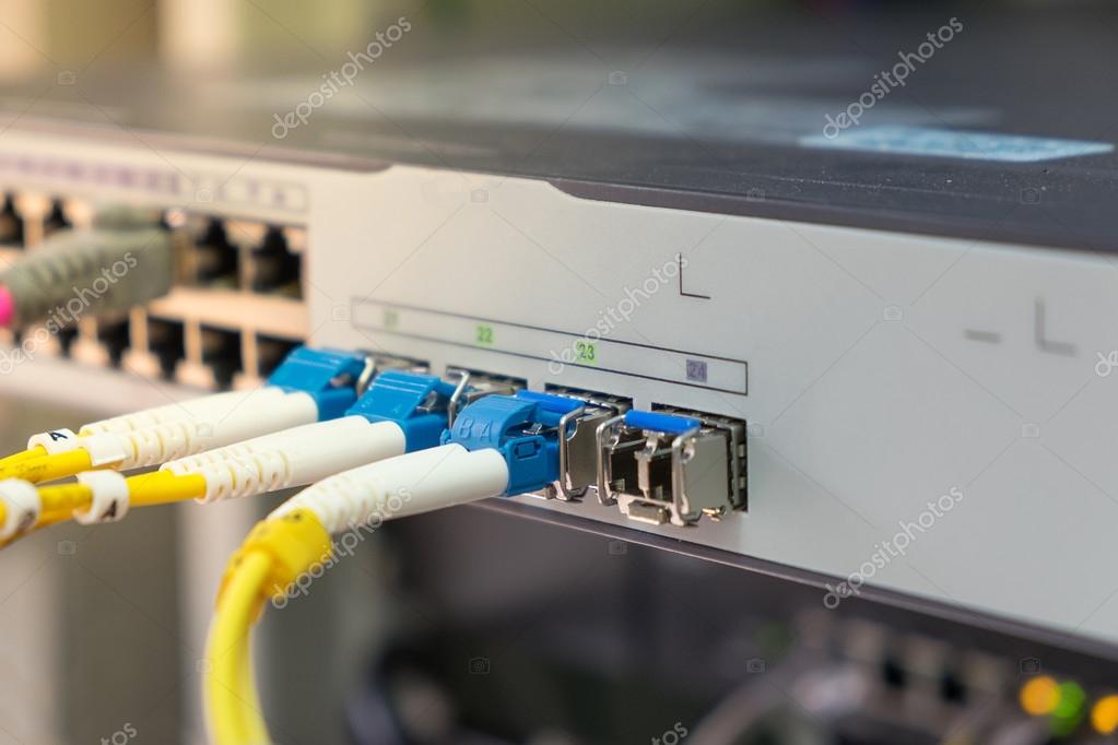 Optical fiber cables plug in in network switch — Stock Photo © john99