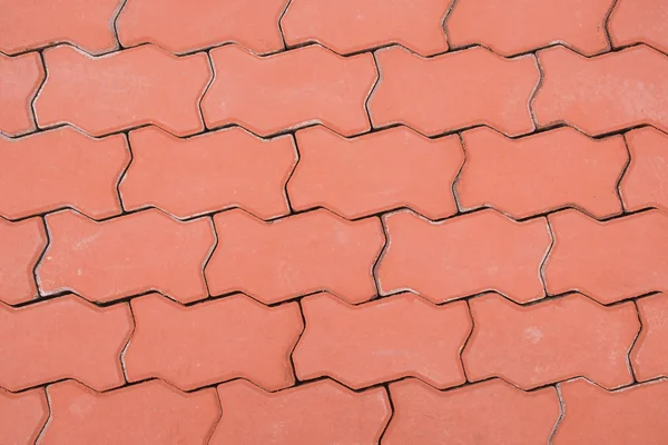 Rode bakstenen straatstenen op een trottoir, patroon van de vloer — Stockfoto