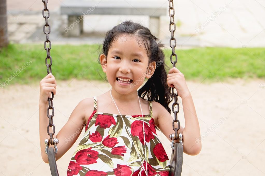 Happy Little Girl on Swing, smiling face