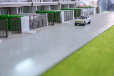 yolun önünde ev modeli üzerinde oyuncak araba