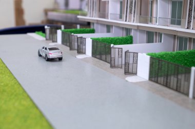 yolun önünde ev modeli üzerinde oyuncak araba