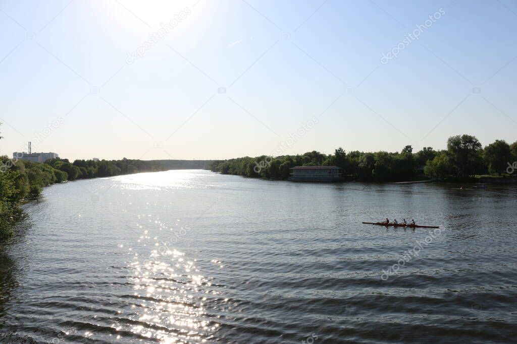people in a kayak float on the river in summer
