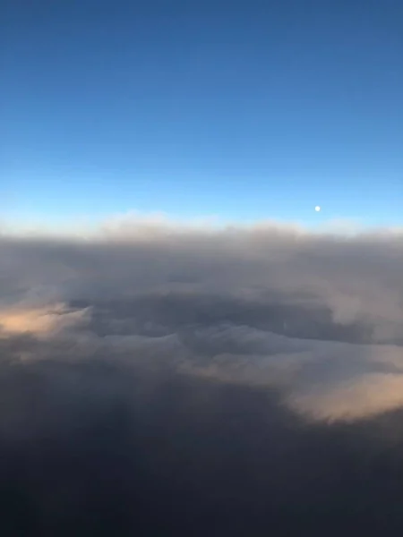 view from the plane window clouds and moon day