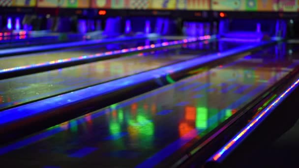 Defocated tenpin bowlingbaan met heldere neon lichten — Stockvideo