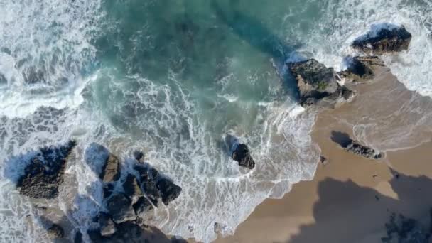 Flygfoto av vågor som träffar stenar som skjutits rakt ovanifrån — Stockvideo