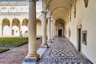 Ziyaretçiler Napoli 'deki Certosa di San Martino müzesinin ana avlusunda yürüyorlar. Mimari tarihi tasarım özelliklerini gösterir.