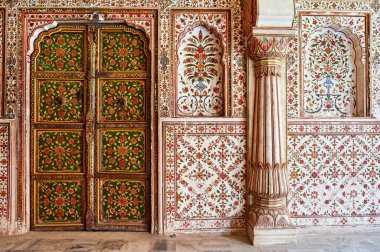 Ziyaretçiler, Bikaner, Rajasthan 'daki Junagarh Kalesi' nin duvarlarındaki ve kapılarındaki karmaşık tasarımlara hayran. Zengin tarih her ayrıntıda görünür..