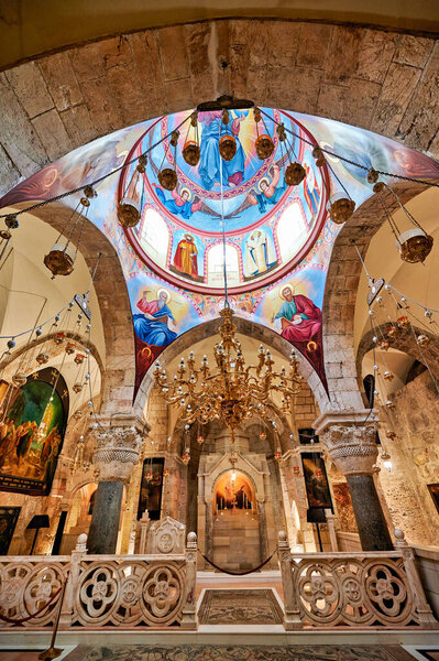 People explore the Holy Sepulchre Church in Jerusalem. They admire the art and architecture in this important religious site.