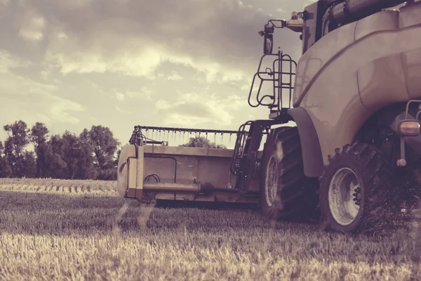 Combine harvester on a wheat field - vintage styel — Stock Photo, Image