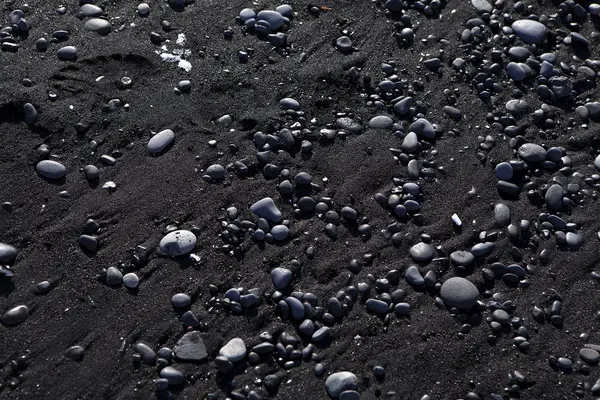 Stone structure at a black sand beach — Stock Photo, Image