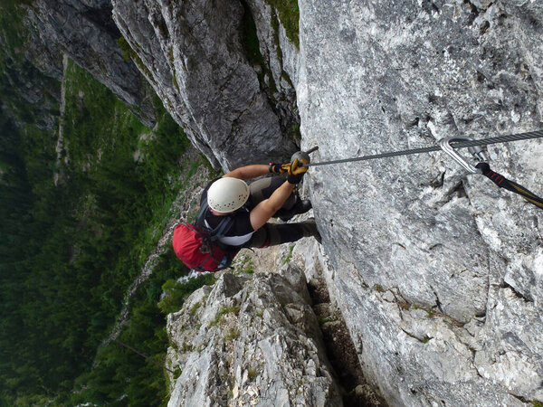 Climber at Seebenklettersteig via ferrata, Tyrol, Austria in summertime