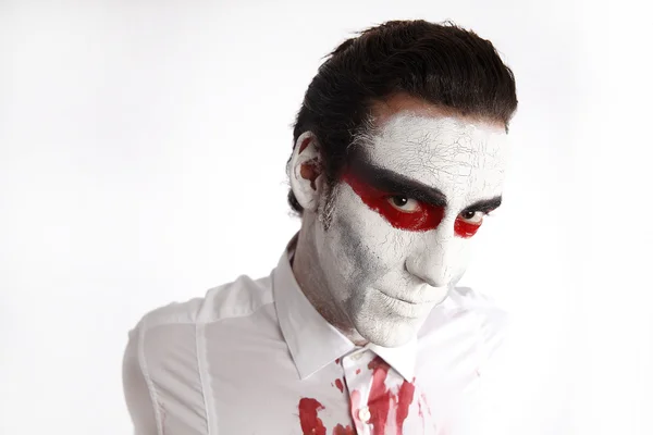 Man with white mascara and bloody shirt — Stock Photo, Image