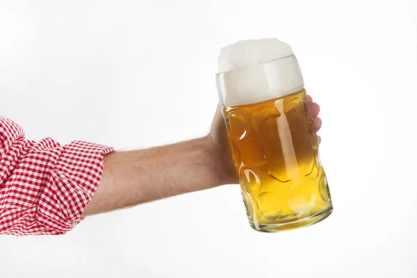 Man in traditional Bavarian shirt holds mug of beer — Stock Photo, Image