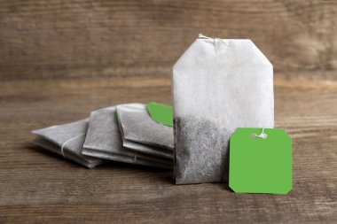 Teabags on wooden background    clipart