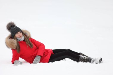 Kışın kar altında kırmızı ceketli genç bir kadın