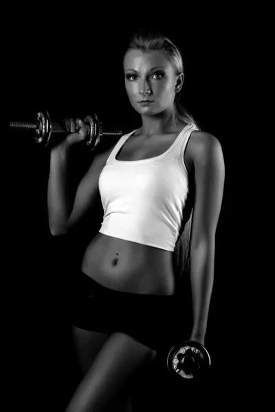 Sexy and fit woman lifting hand weights — Stock Photo, Image
