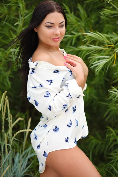 Girl on a background of grass in a shirt and underwear — Stock Photo, Image