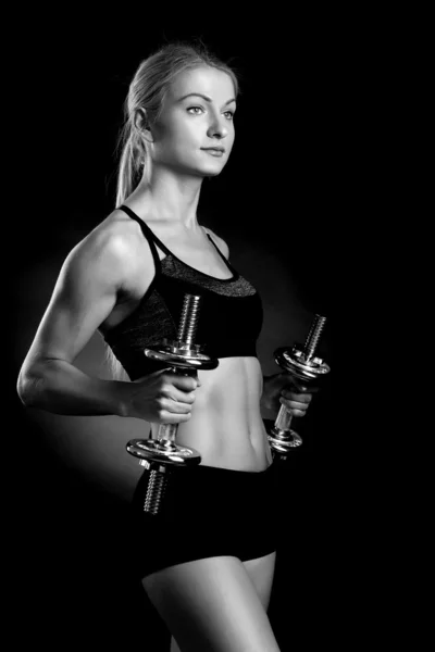 Sexy and fit woman lifting hand weights — Stock Photo, Image