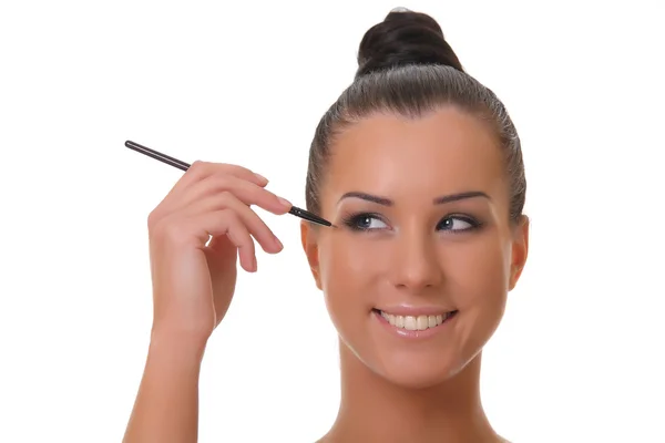 Beautiful young woman holds the make-up brushes — Stock Photo, Image