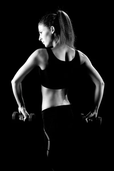 Beautiful sporty muscular woman working out with dumbbells — Stock Photo, Image